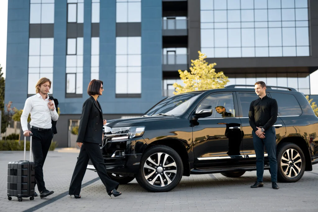 business-couple-walk-with-suitcase-car-trip-1-1024x683